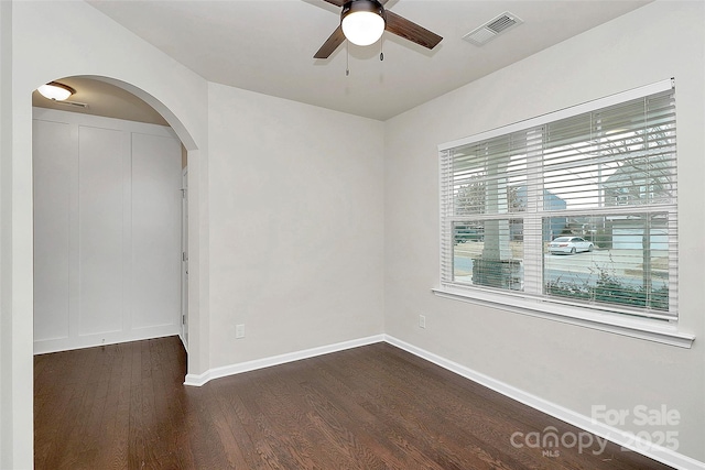 empty room featuring dark wood-type flooring and ceiling fan