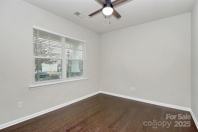 unfurnished room featuring dark wood-type flooring and ceiling fan