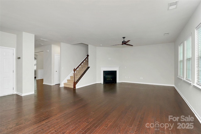 unfurnished living room with dark hardwood / wood-style floors and ceiling fan