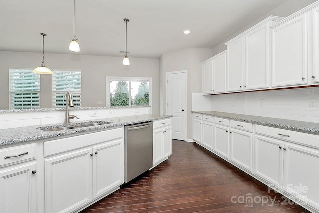 kitchen featuring decorative light fixtures, white cabinetry, dishwasher, sink, and light stone countertops