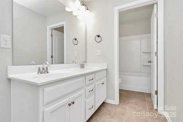 bathroom with vanity, tile patterned flooring, and toilet