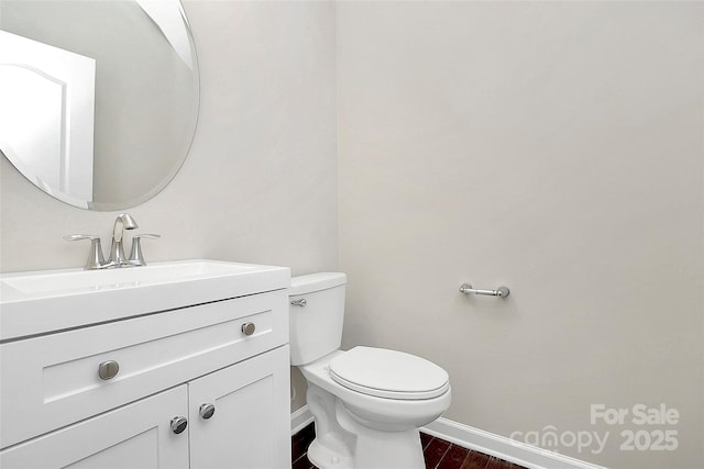 bathroom featuring hardwood / wood-style flooring, vanity, and toilet