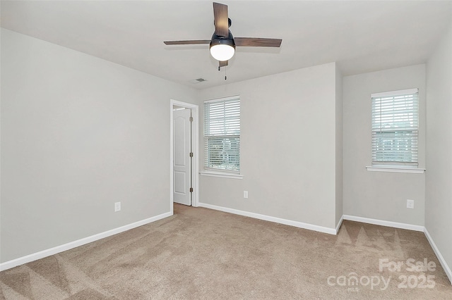 unfurnished room featuring light carpet and ceiling fan