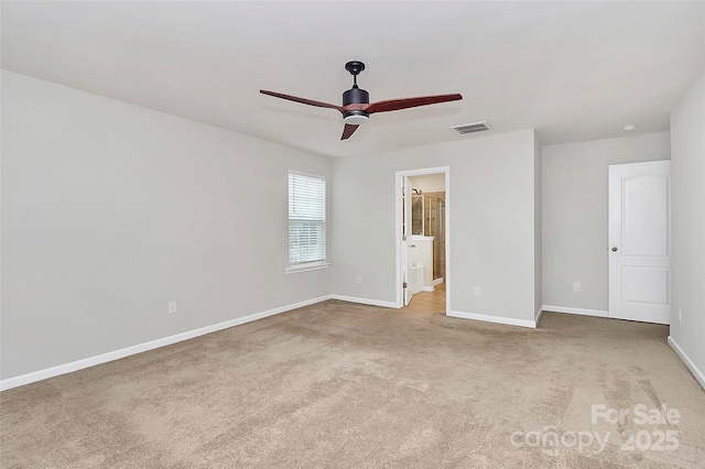 unfurnished bedroom featuring ceiling fan, light colored carpet, and ensuite bathroom