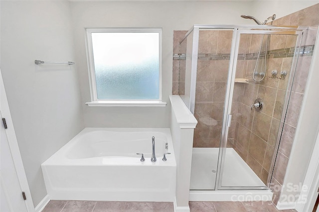 bathroom with tile patterned flooring and separate shower and tub