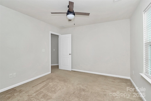 unfurnished room featuring ceiling fan, a healthy amount of sunlight, and carpet flooring