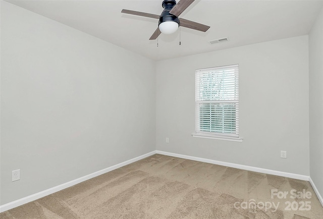 carpeted spare room featuring ceiling fan