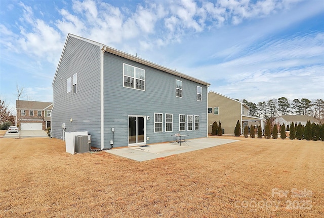 rear view of house with central AC, a lawn, and a patio area