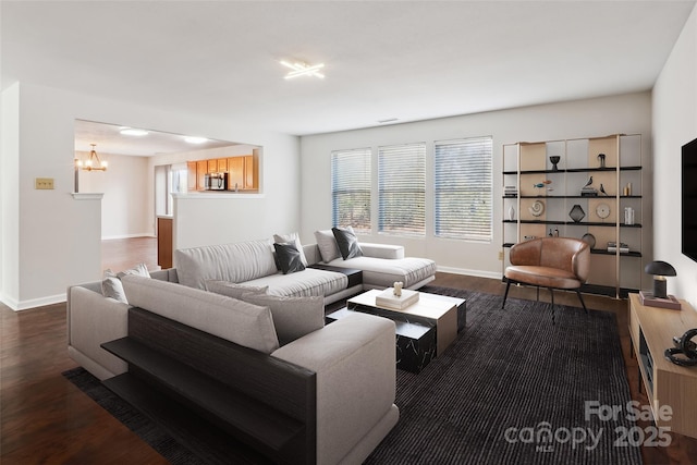 living room featuring dark hardwood / wood-style floors and a chandelier