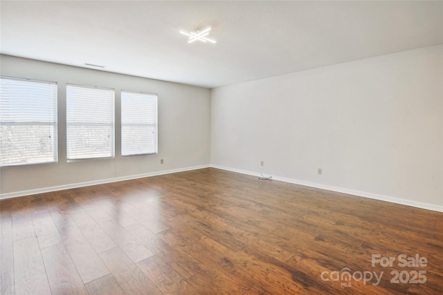 unfurnished room featuring dark hardwood / wood-style floors