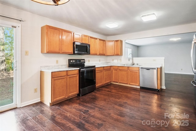 kitchen featuring sink, dark wood-type flooring, black electric range, and dishwasher