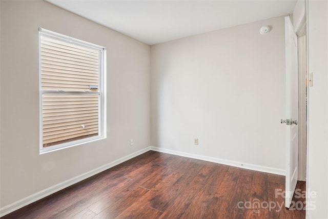 spare room featuring dark hardwood / wood-style floors