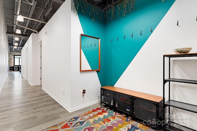 hallway with hardwood / wood-style flooring