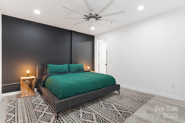 bedroom with ceiling fan and light wood-type flooring