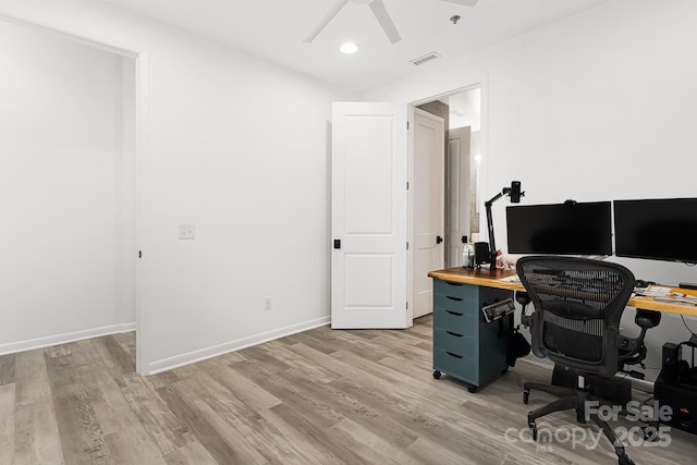 office with ceiling fan and light hardwood / wood-style flooring