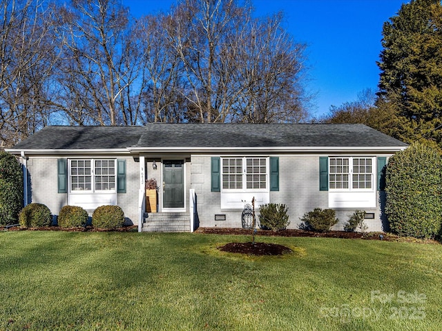 ranch-style home with a front lawn