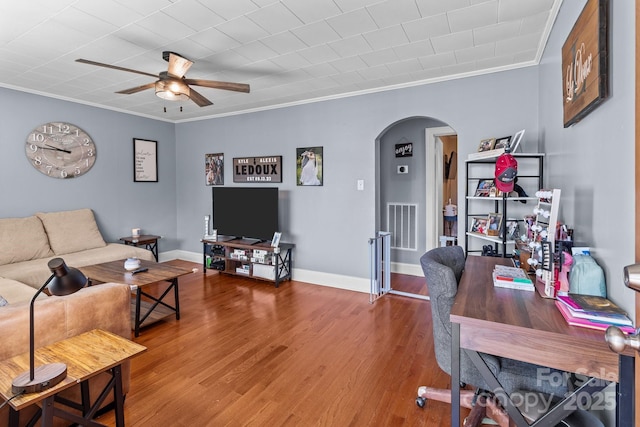 living room featuring hardwood / wood-style flooring, ornamental molding, and ceiling fan