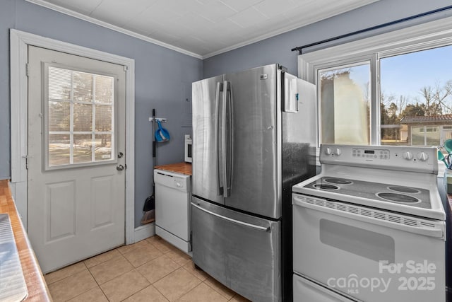 kitchen featuring light tile patterned floors, white appliances, and ornamental molding