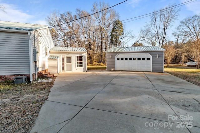 view of property exterior with a garage and an outbuilding