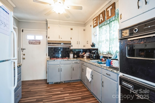 kitchen with sink, white cabinets, backsplash, white fridge, and wall oven