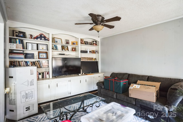 living room featuring ornamental molding, ceiling fan, and a textured ceiling