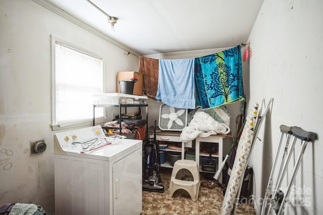 clothes washing area featuring washer / dryer and a wealth of natural light