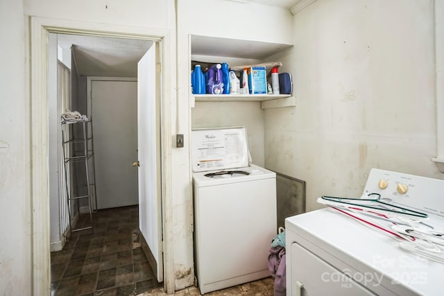 laundry room featuring washing machine and clothes dryer