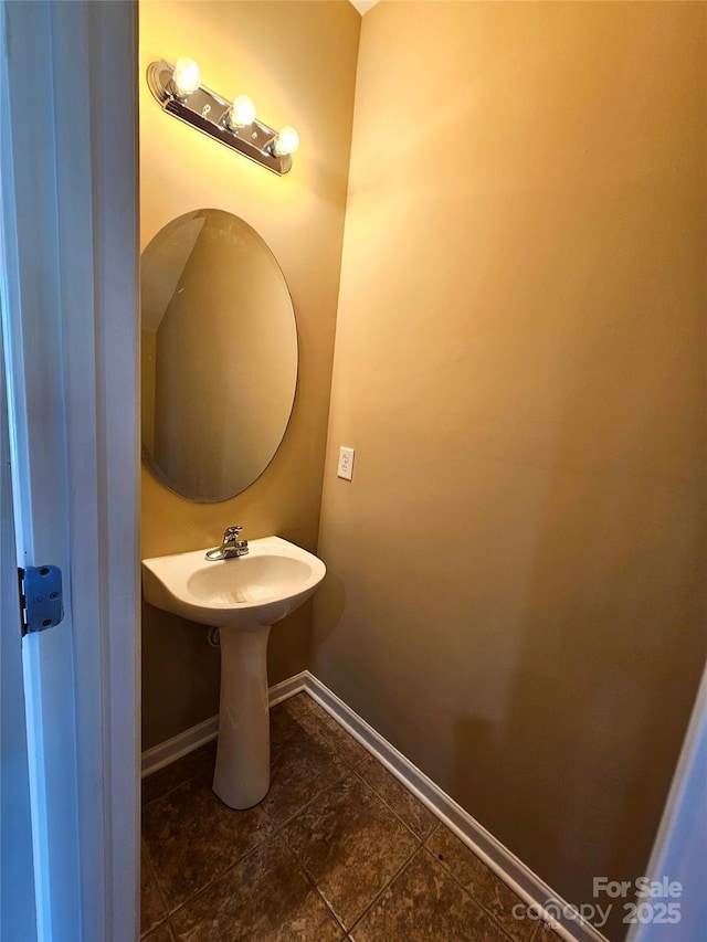 bathroom featuring a sink and baseboards