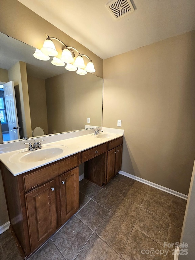 full bath with double vanity, visible vents, baseboards, and a sink