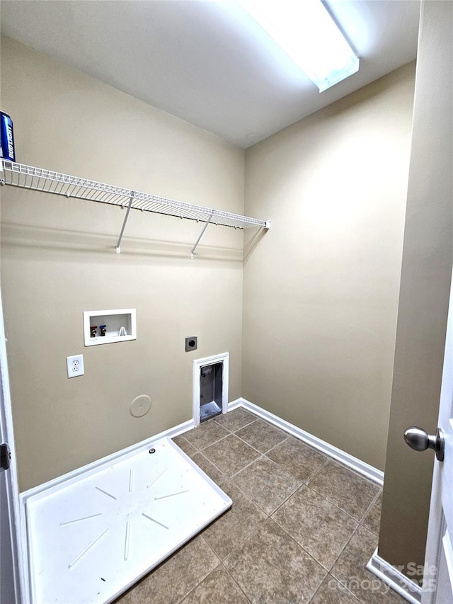 clothes washing area featuring tile patterned flooring, baseboards, laundry area, hookup for a washing machine, and electric dryer hookup