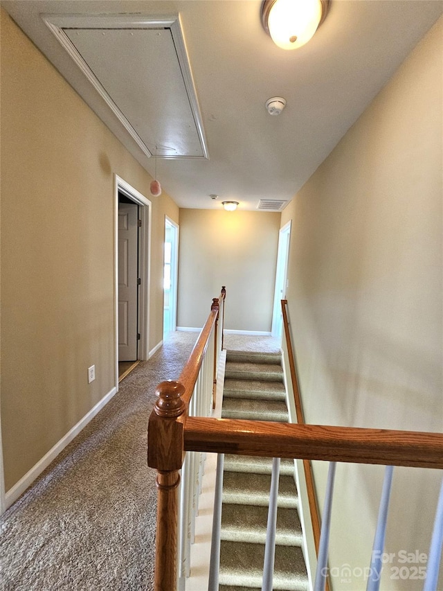 staircase with carpet flooring, visible vents, attic access, and baseboards