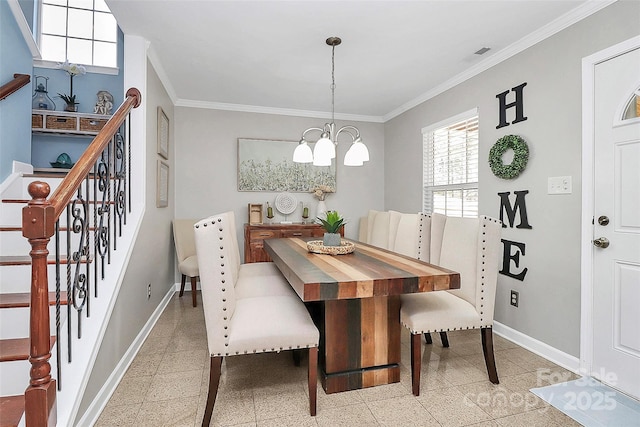 dining space with crown molding and a chandelier