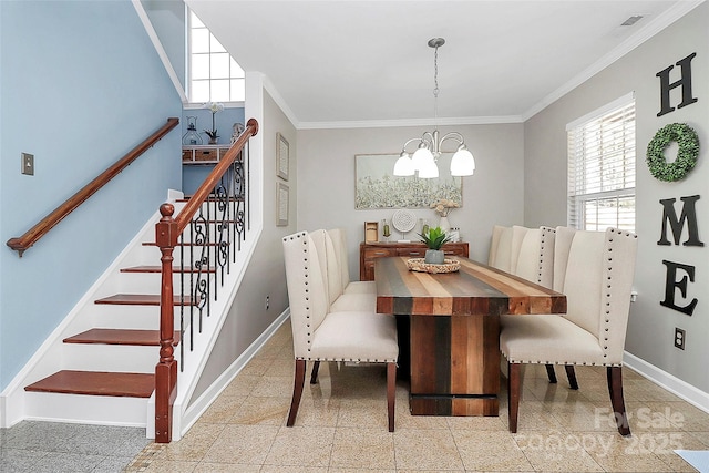 dining space featuring crown molding and an inviting chandelier