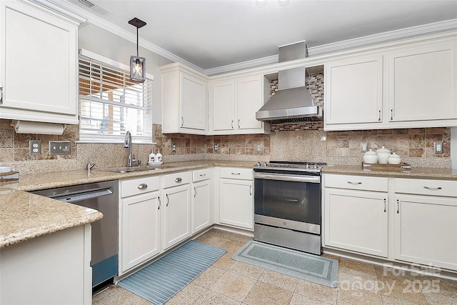 kitchen featuring decorative light fixtures, white cabinetry, sink, stainless steel appliances, and wall chimney range hood