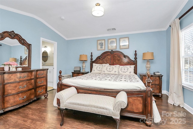 bedroom with lofted ceiling, ensuite bath, dark wood-type flooring, and ornamental molding