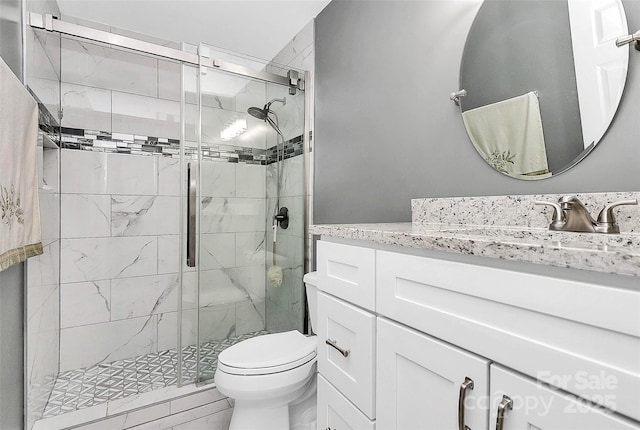 bathroom with vanity, toilet, and an enclosed shower