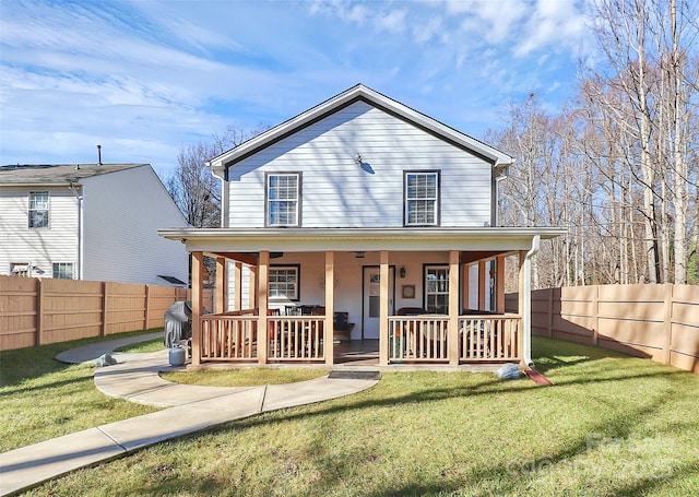 farmhouse featuring covered porch and a front lawn