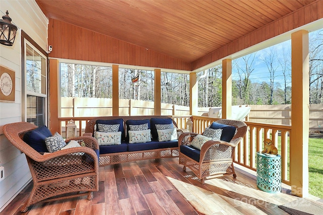 sunroom featuring lofted ceiling and wood ceiling