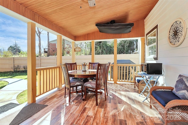 sunroom / solarium featuring vaulted ceiling and wooden ceiling