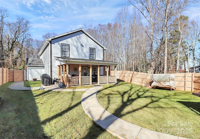 rear view of house featuring a lawn