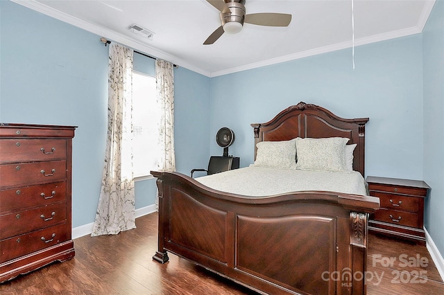 bedroom featuring crown molding, dark wood-type flooring, and ceiling fan