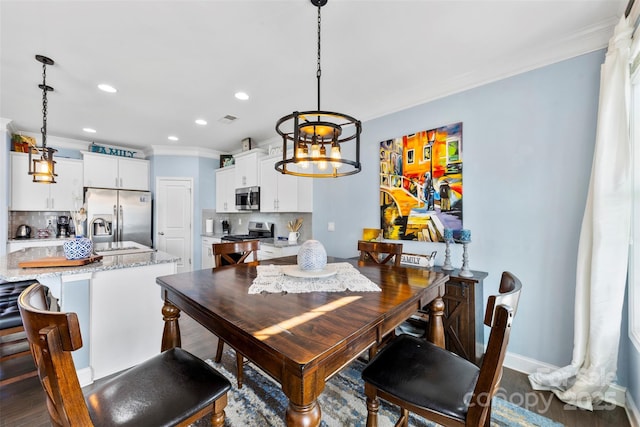 dining area featuring crown molding and sink