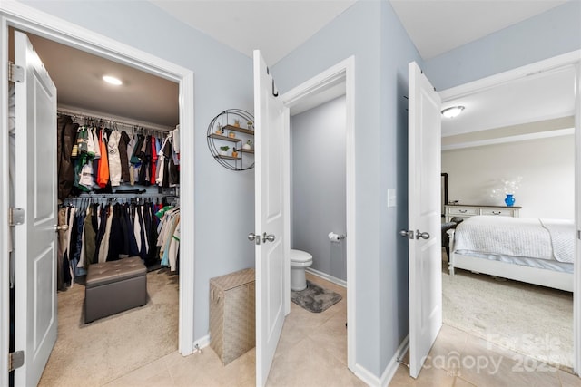 bedroom with a closet and light carpet