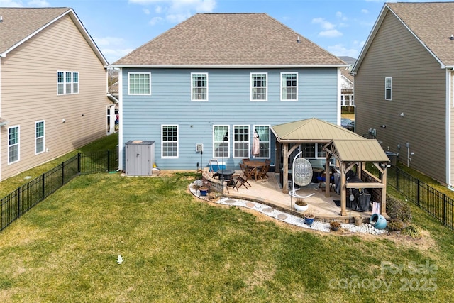 back of property featuring a gazebo, a yard, and a patio area