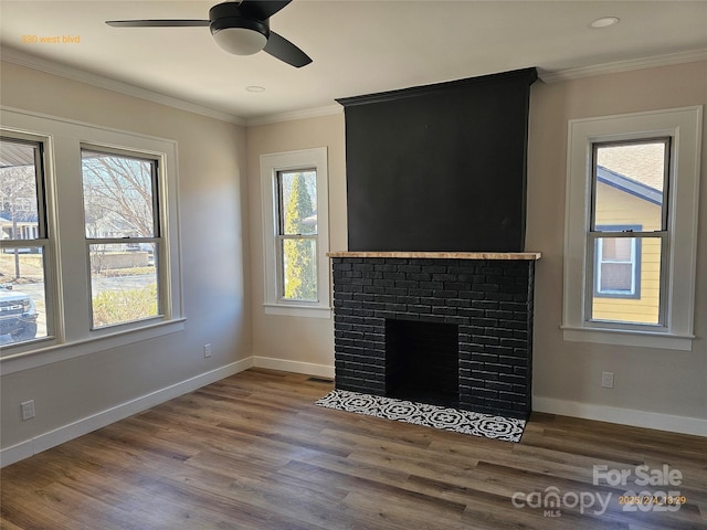 unfurnished living room featuring hardwood / wood-style flooring, a fireplace, ornamental molding, and ceiling fan