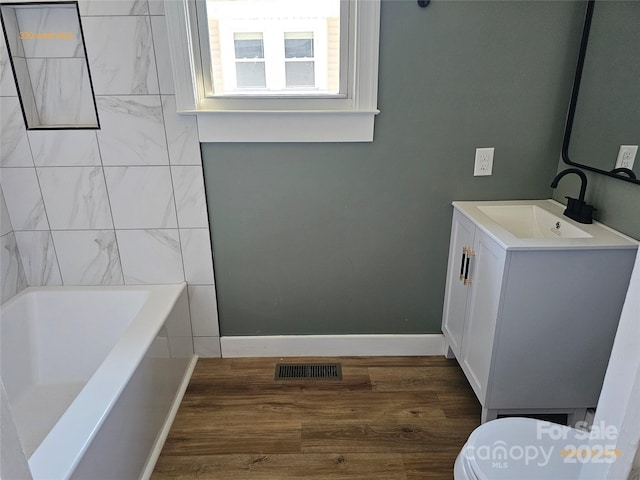 bathroom with hardwood / wood-style flooring, vanity, and toilet