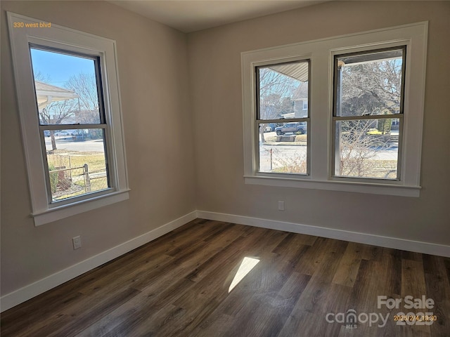 empty room with dark hardwood / wood-style floors