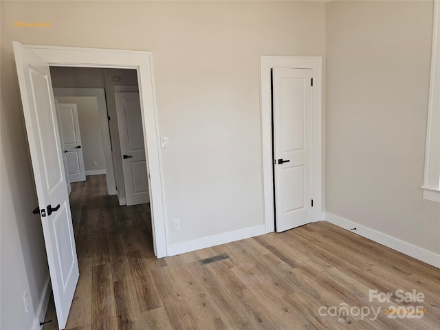 unfurnished bedroom featuring wood-type flooring