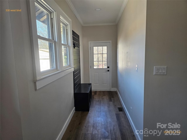 doorway to outside with crown molding and dark wood-type flooring