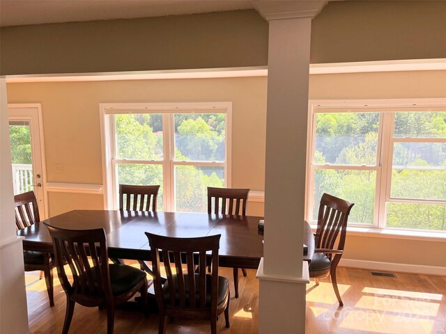 dining space with baseboards, visible vents, and light wood-style flooring